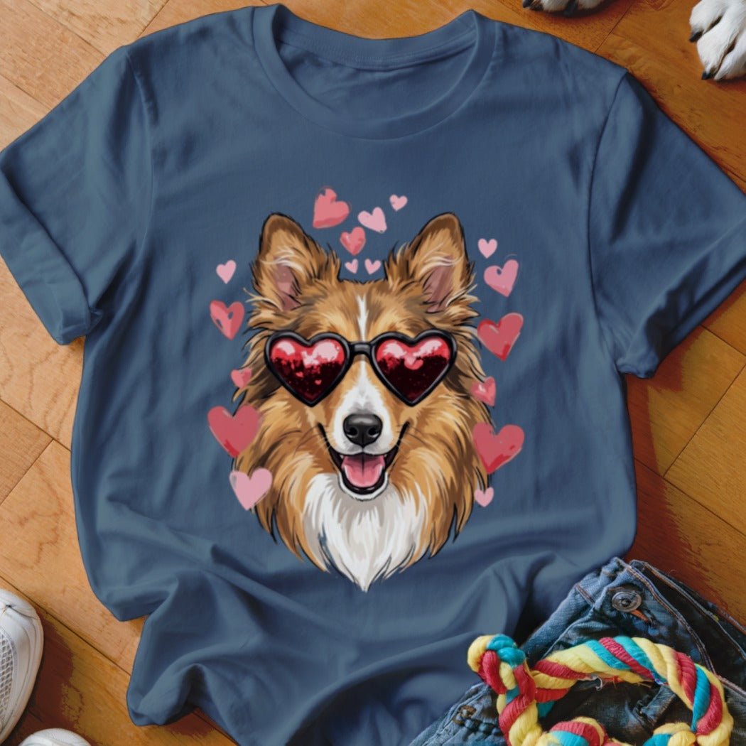 A dark blue crewneck t-shirt featuring a graphic of a smiling collie wearing heart-shaped sunglasses, surrounded by pink hearts.