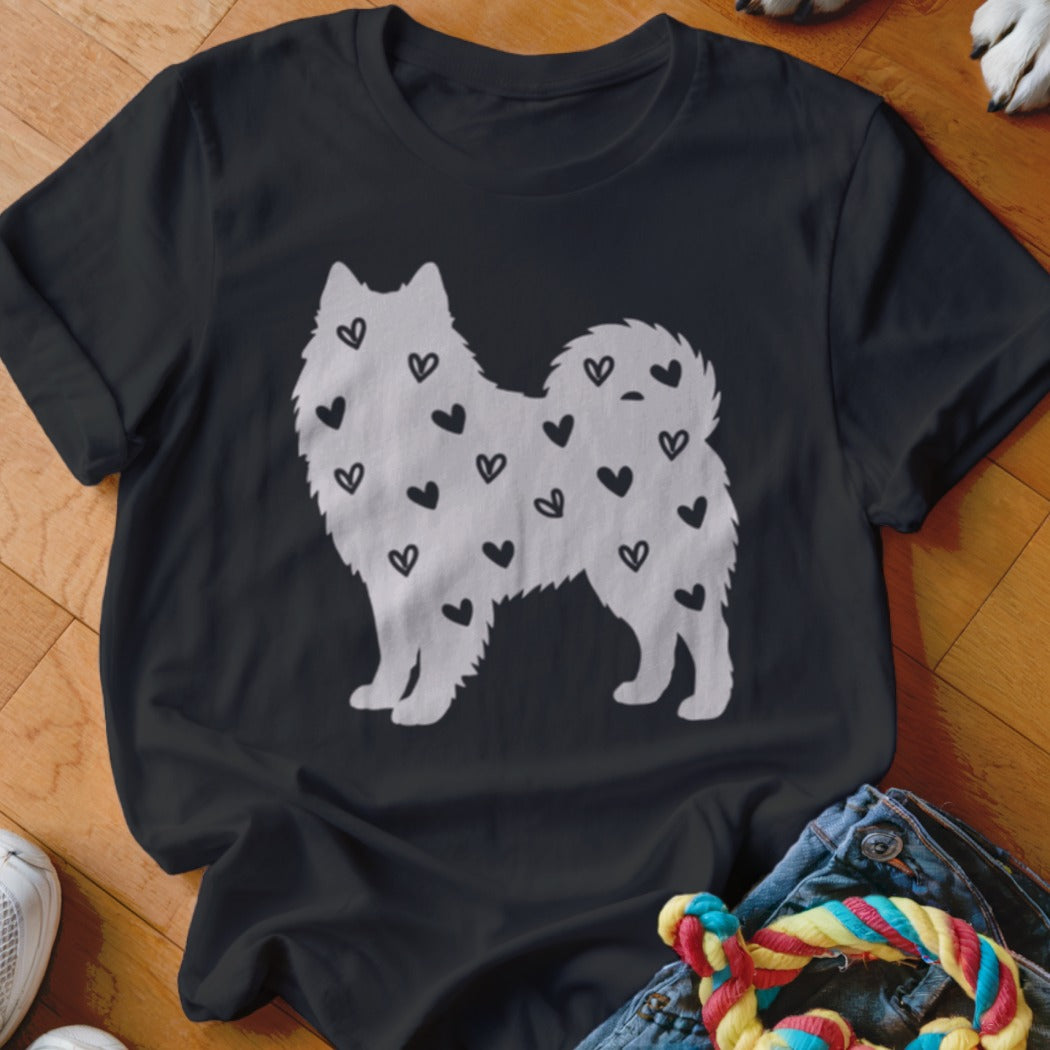 Black t-shirt with a white silhouette of a fluffy dog covered in small black hearts.