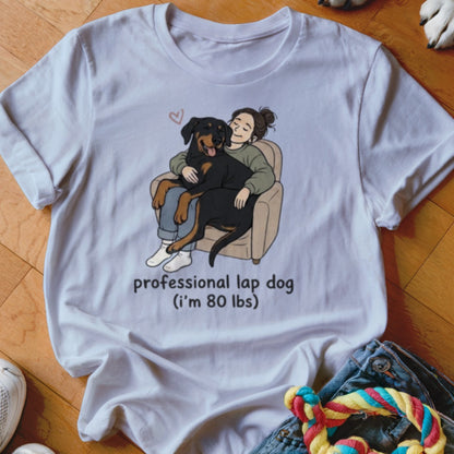 White t-shirt with illustration of woman hugging Rottweiler titled "professional lap dog".
