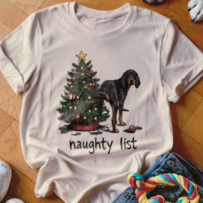 Black and tan dog pees on Christmas tree with "naughty list" text.