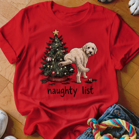 Red t-shirt with a doodle dog lifting its leg on a Christmas tree, saying "naughty list."
