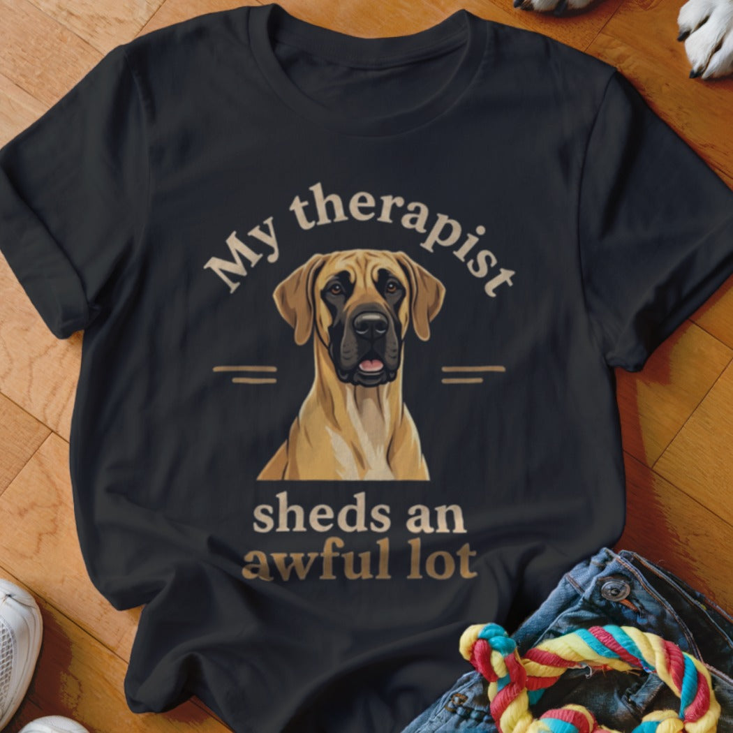 Black t-shirt featuring a fawn-colored dog graphic and the text My therapist sheds an awful lot.