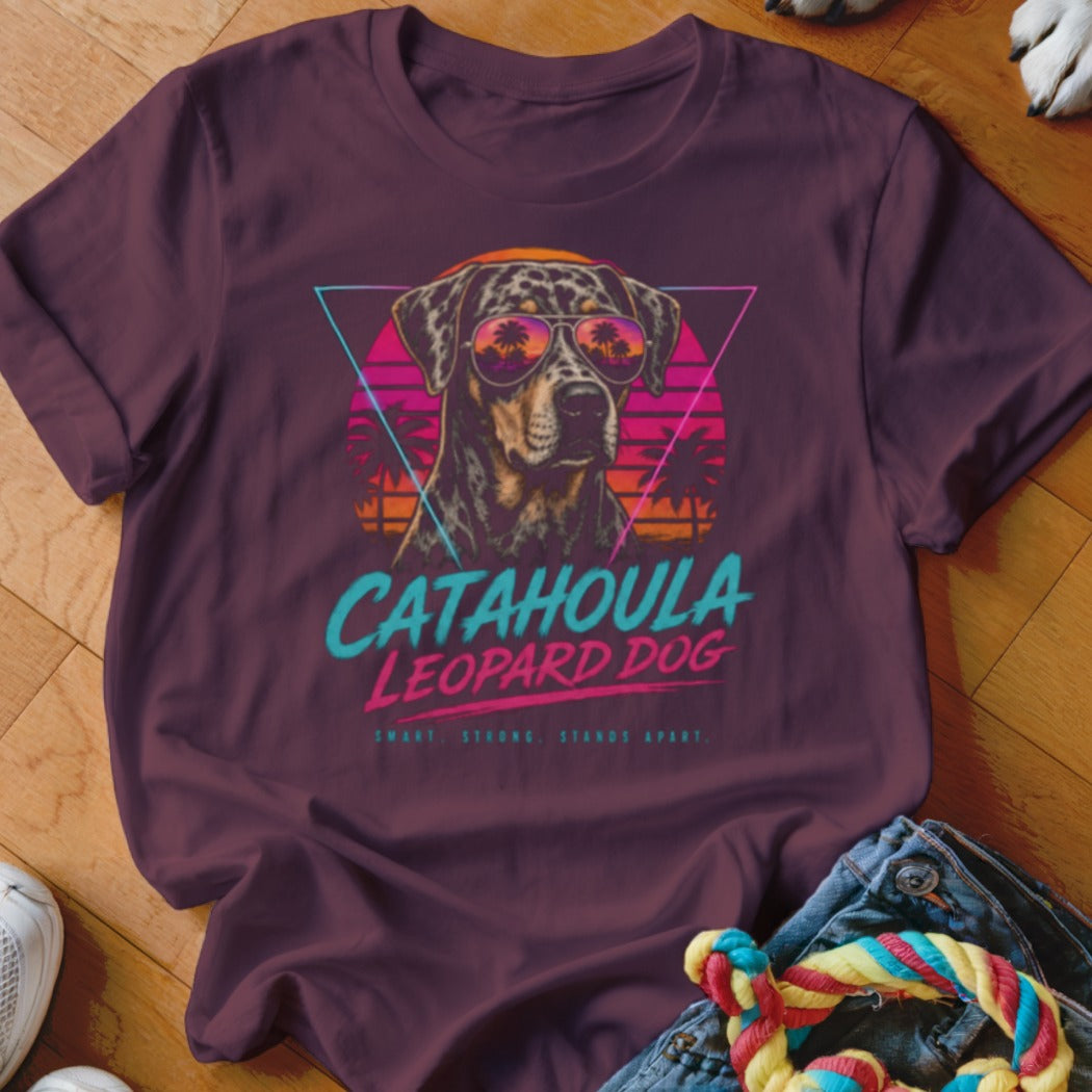 Catahoula Leopard Dog graphic on a maroon t-shirt with sunset mountain and palm tree design.