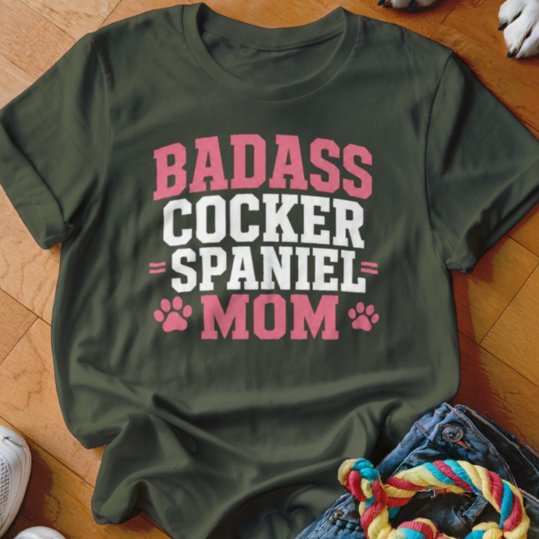 Dark green t-shirt with "BADASS COCKER SPANIEL MOM" text in pink and white.