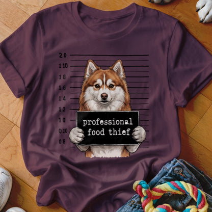 Husky dog with mugshot sign that says "professional food thief."