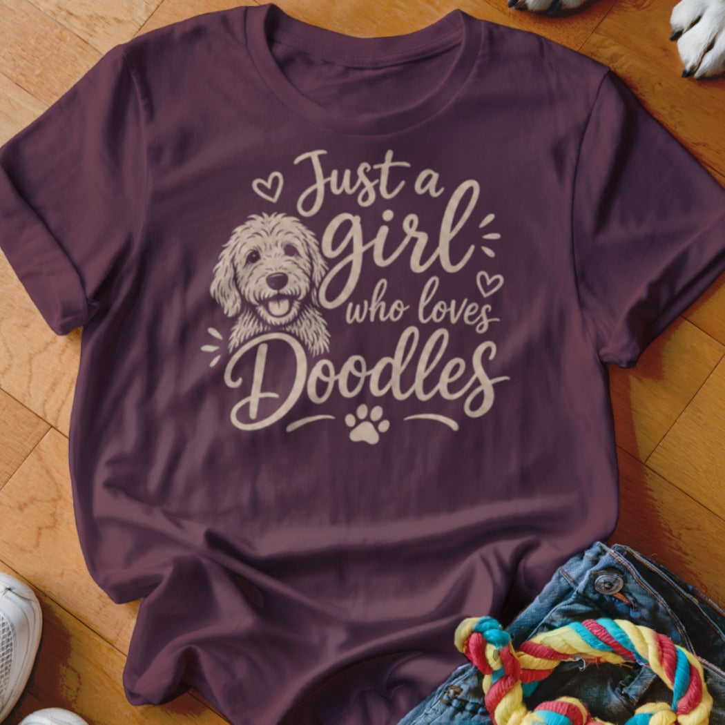 Burgundy t-shirt with white text and dog graphic reading "Just a girl who loves Doodles".