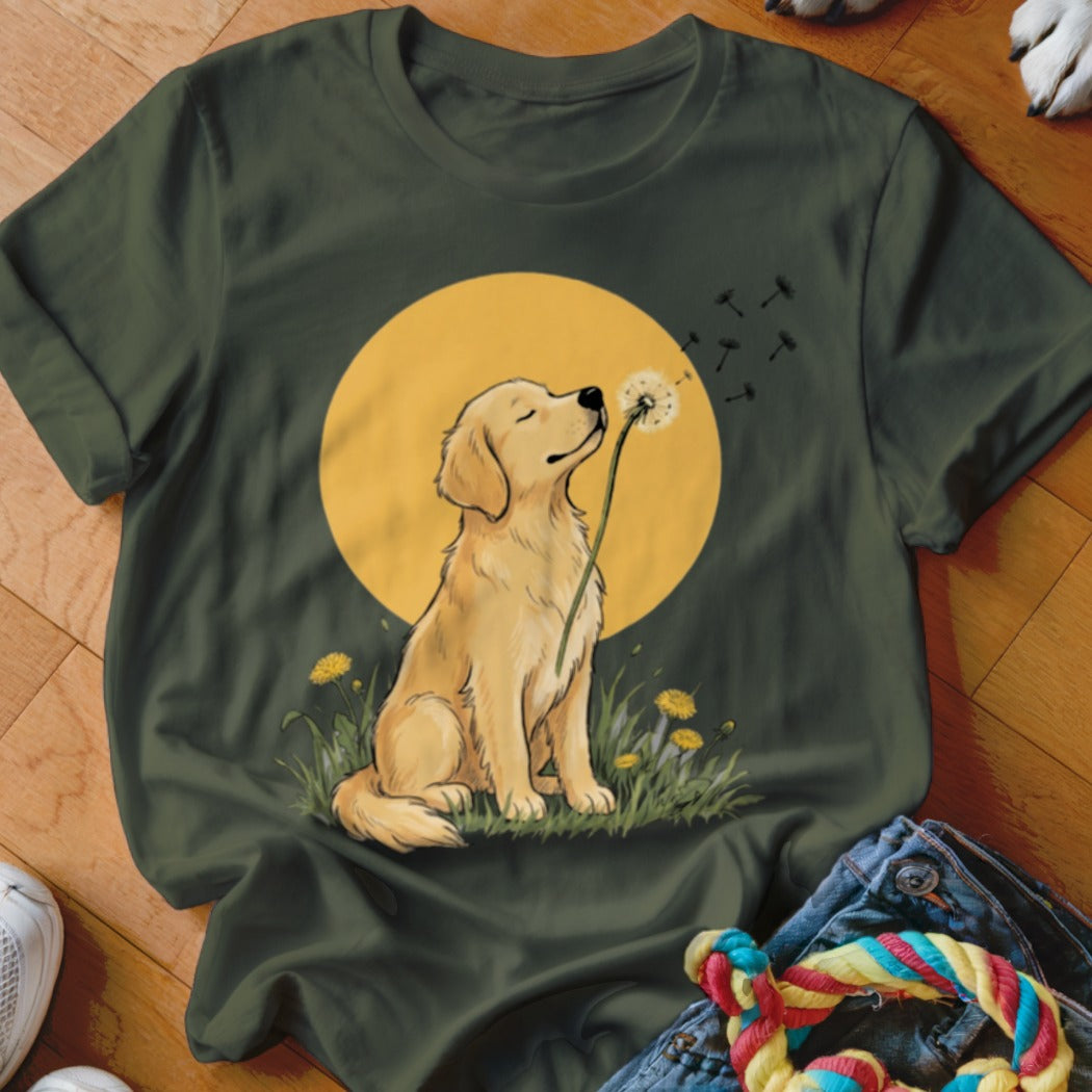 Dark green t-shirt featuring a golden retriever blowing dandelion seeds against a large yellow circle.