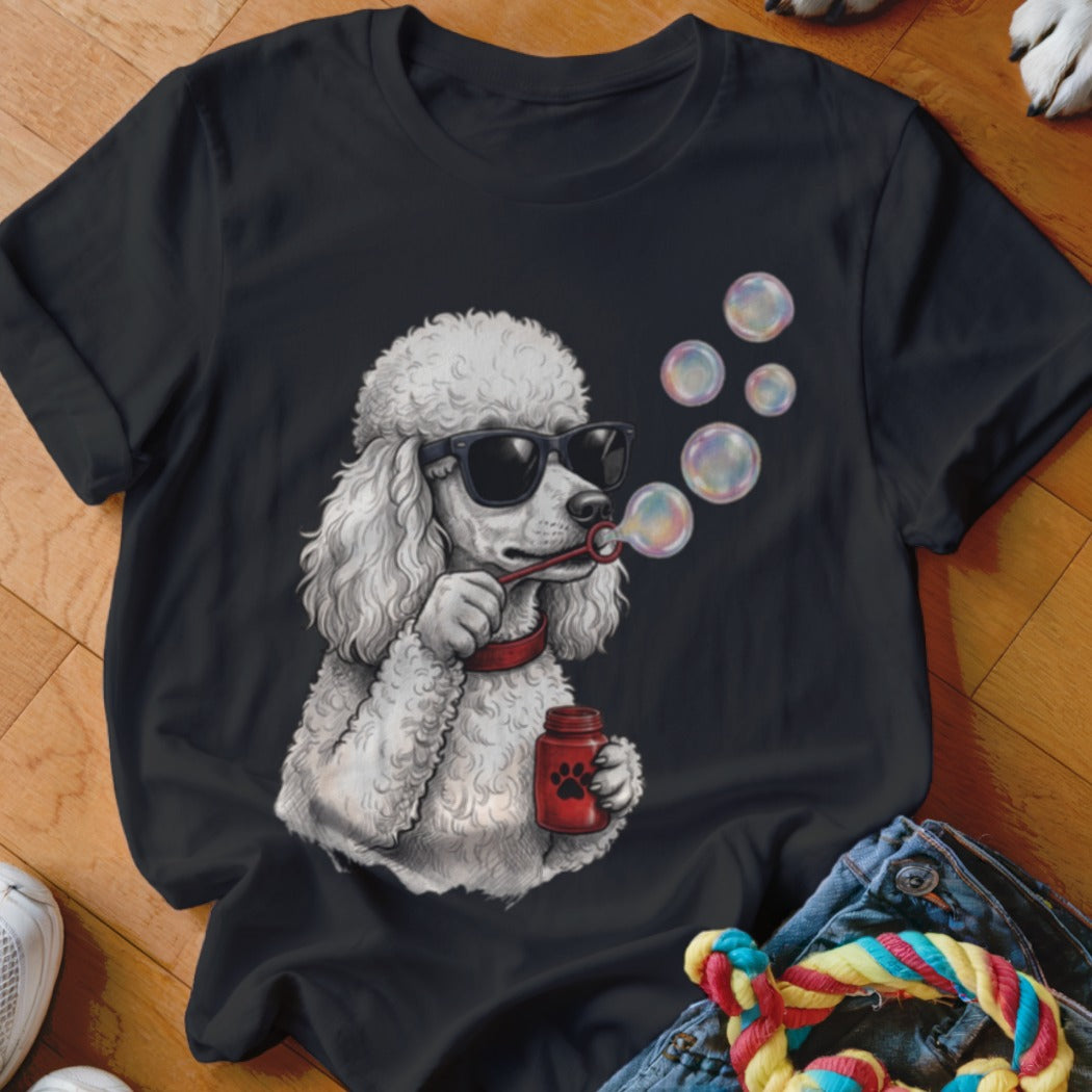 Black t-shirt featuring a graphic of a white poodle wearing sunglasses and blowing bubbles.