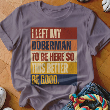 Purple t-shirt with text "I left my Doberman to be here so this better be good."