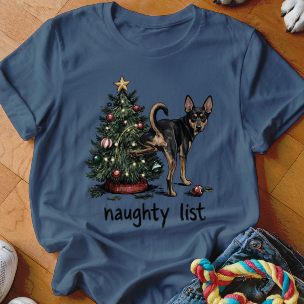 Dog lifting leg on Christmas tree with "naughty list" text below.