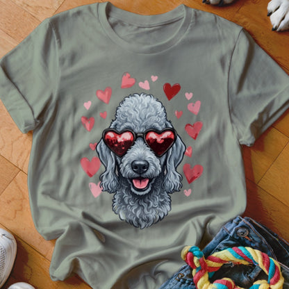 Sage green t-shirt featuring a graphic of a grey poodle wearing heart-shaped sunglasses surrounded by floating hearts.