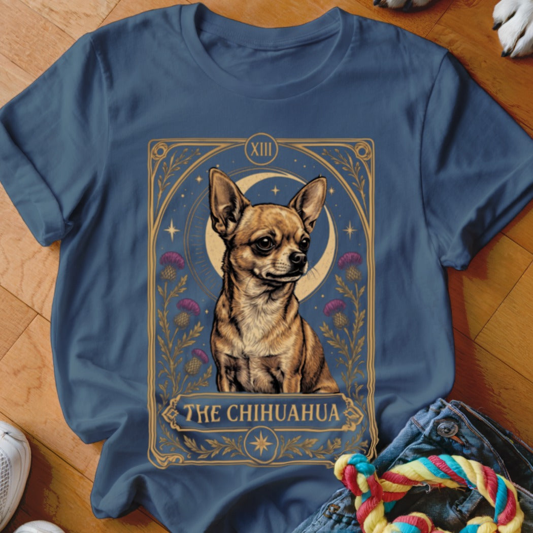 A blue t-shirt featuring a tarot card graphic of a chihuahua with flowers and the text The Chihuahua.