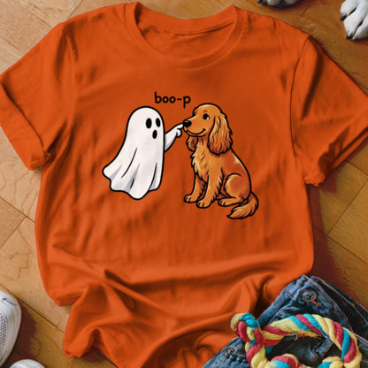 Ghost boops a golden dog with text "boo-p" on orange shirt.