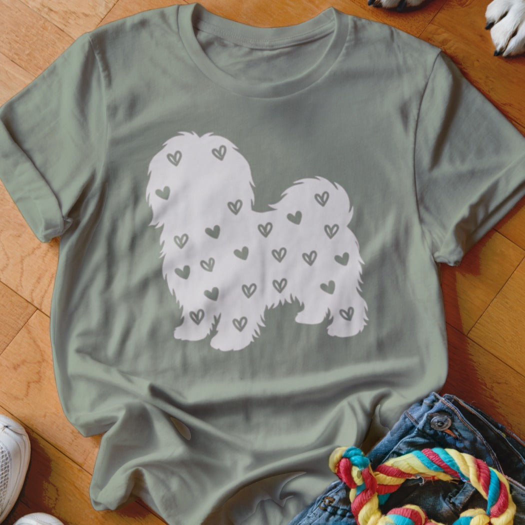 T-shirt with white silhouette of fluffy dog covered in small heart shapes.