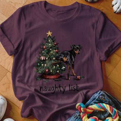 Maroon t-shirt with a dog next to a Christmas tree and the words "naughty list".