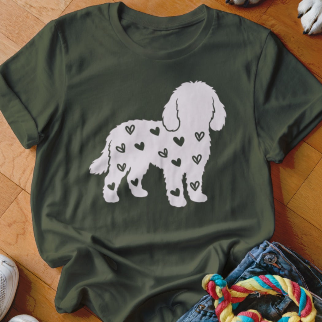 Green t-shirt with white poodle silhouette covered in small black hearts.