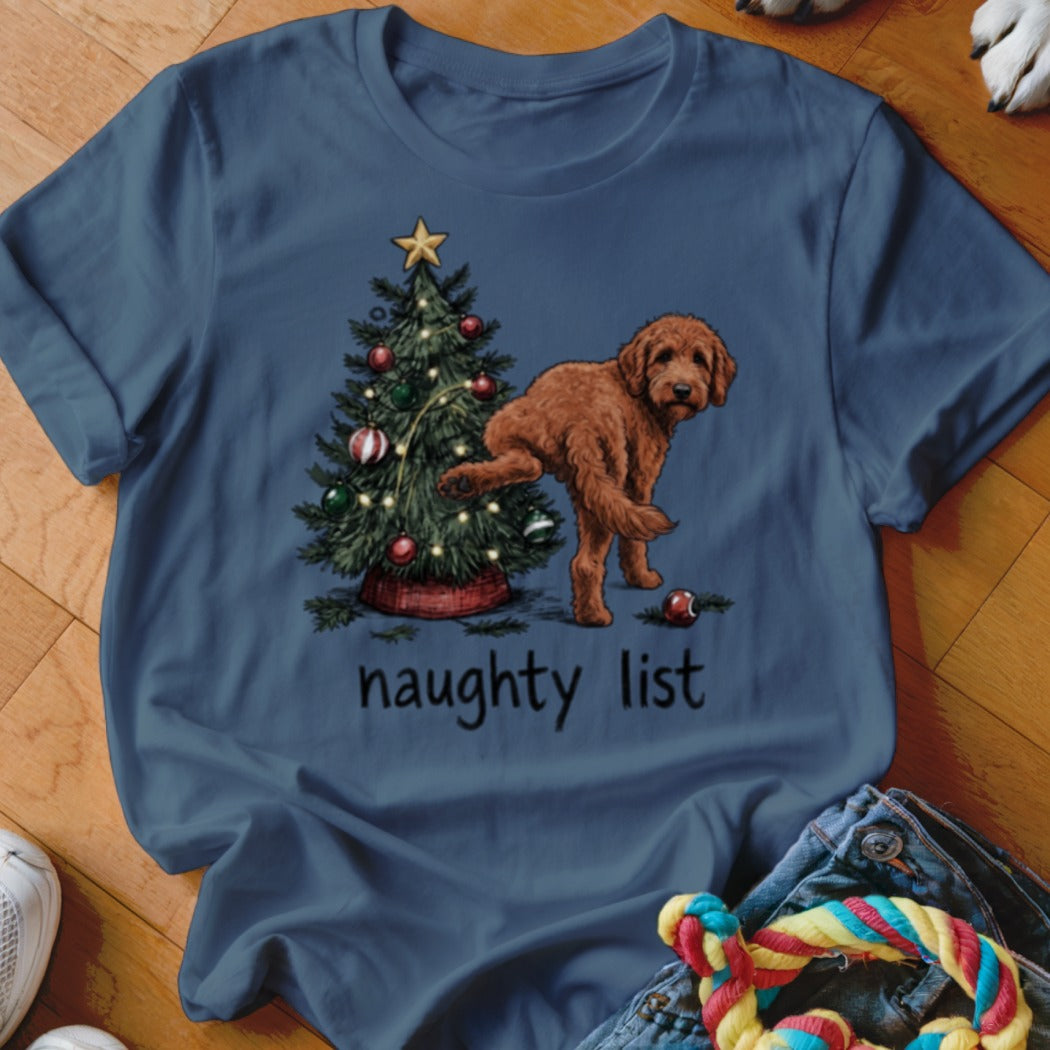 Brown dog lifting leg on Christmas tree with text "naughty list".