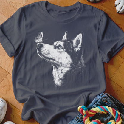 A dark gray crewneck t-shirt featuring a white sketch of a husky looking at a butterfly.