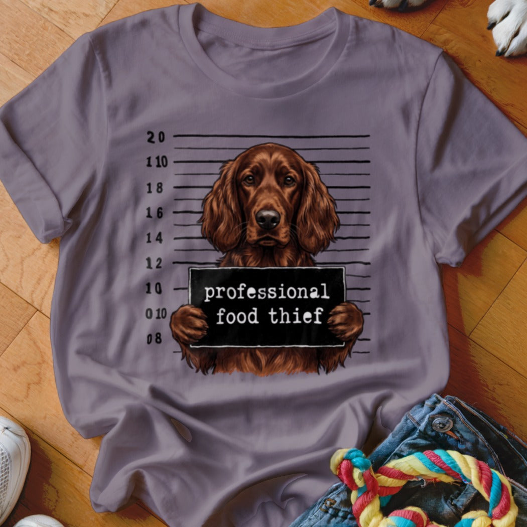 Irish setter mugshot with text "professional food thief" on shirt.
