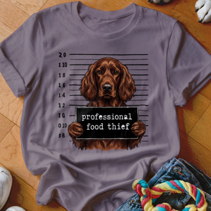 Irish setter mugshot with text "professional food thief" on shirt.