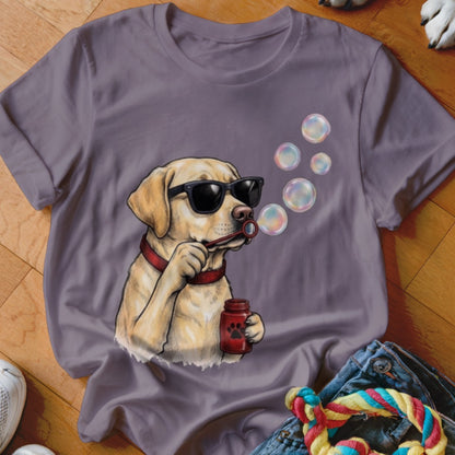 A purple crewneck t-shirt featuring a graphic of a yellow lab wearing sunglasses and blowing bubbles.