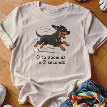 T-shirt with a cartoon dog running and text "0 to zoomies in 2 seconds."