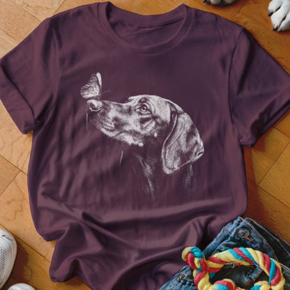 A dark maroon t-shirt featuring a white line drawing of a dog looking at a butterfly on its nose.