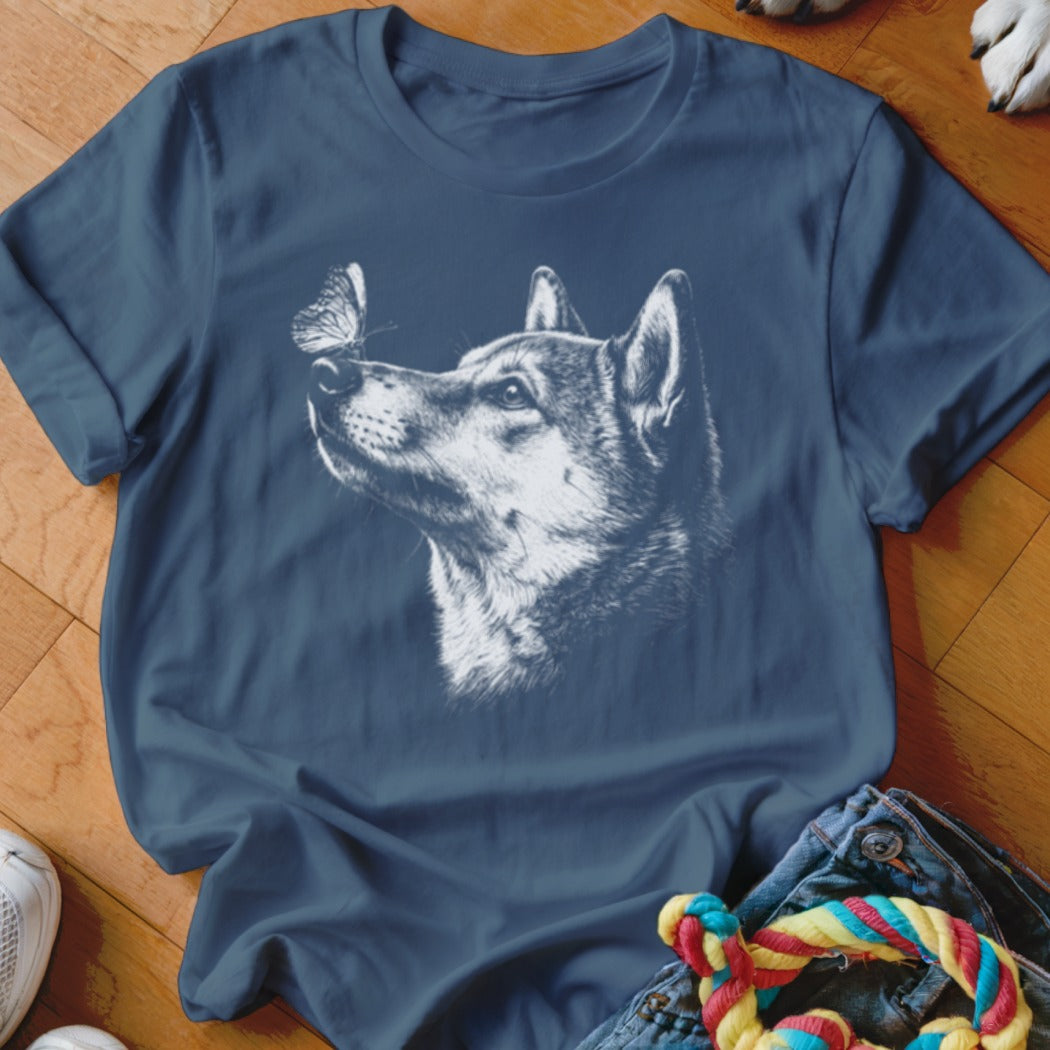 A navy blue crewneck t-shirt featuring a white sketch graphic of a dog looking at a butterfly.