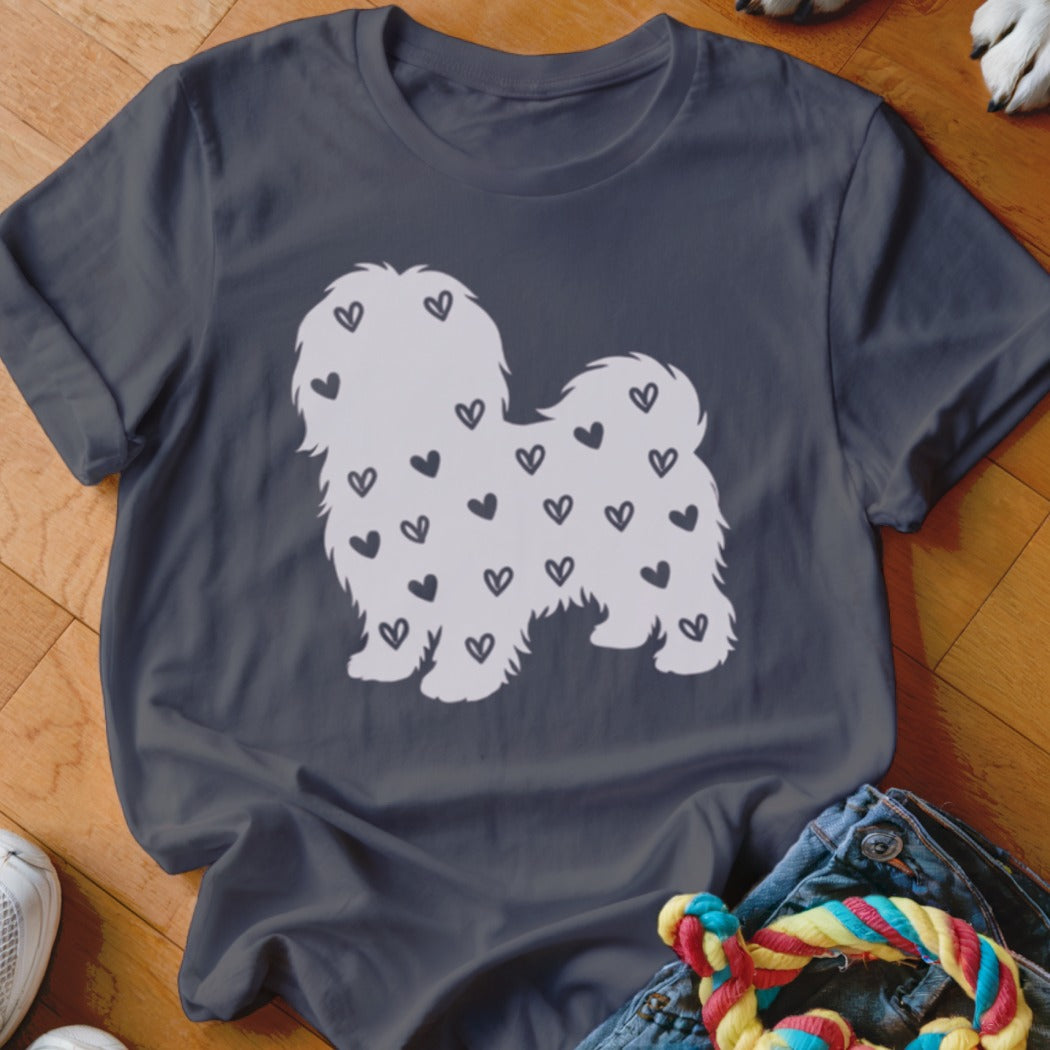 White shaggy dog silhouette filled with small black hearts on a dark grey t-shirt.