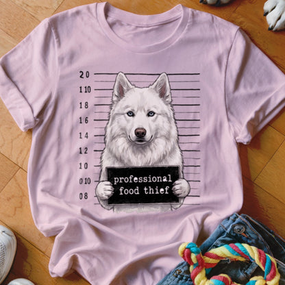 Pink t-shirt with a mugshot of a white husky holding a "professional food thief" sign.