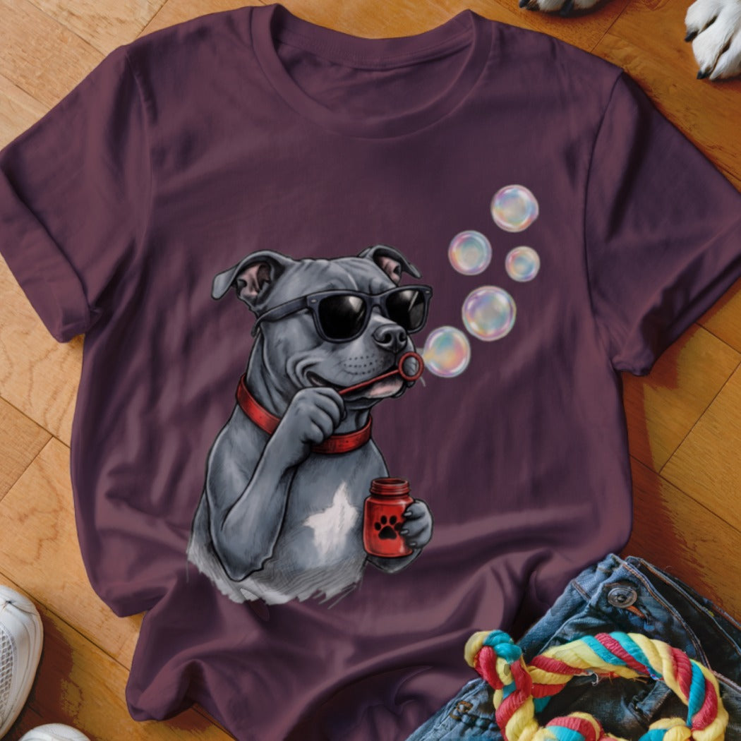 Plum-colored t-shirt featuring a graphic of a grey pitbull wearing sunglasses and blowing bubbles.