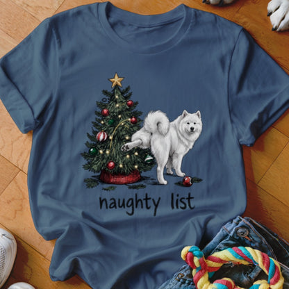 Dark blue t-shirt featuring a Samoyed dog lifting its leg at a decorated Christmas tree with the text naughty list underneath.