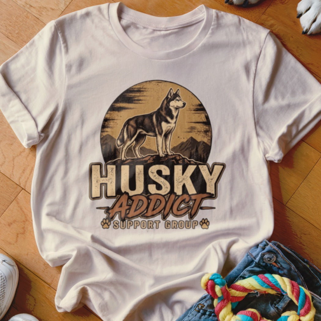 Beige t-shirt featuring a graphic of a husky on a mountain with the text Husky Addict Support Group.