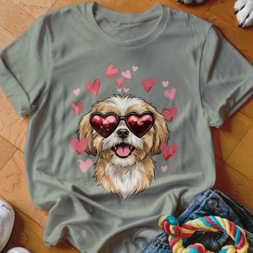 Sage green t-shirt featuring a graphic of a fluffy dog wearing heart-shaped sunglasses surrounded by pink hearts.