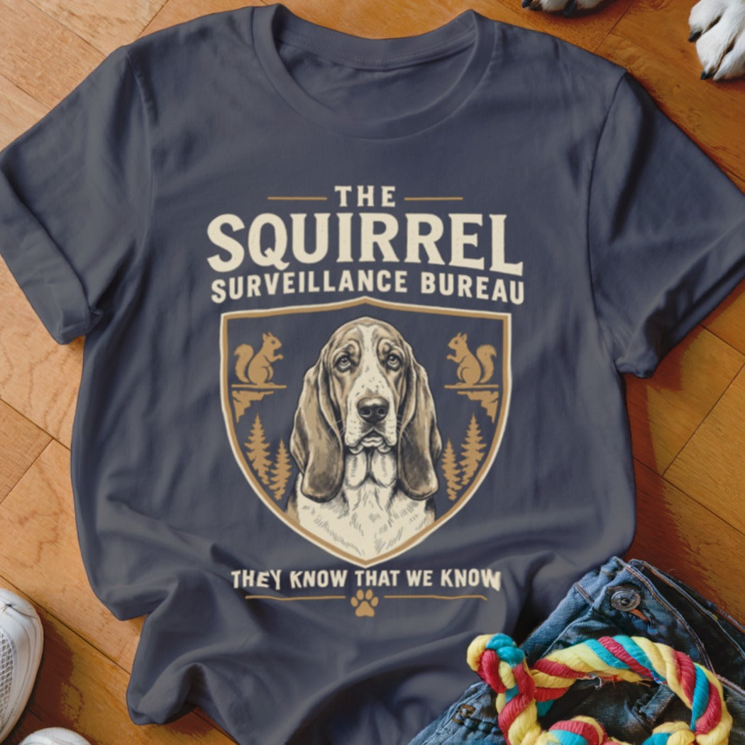 Dark gray t-shirt with a graphic of a basset hound and squirrels, featuring the text The Squirrel Surveillance Bureau.