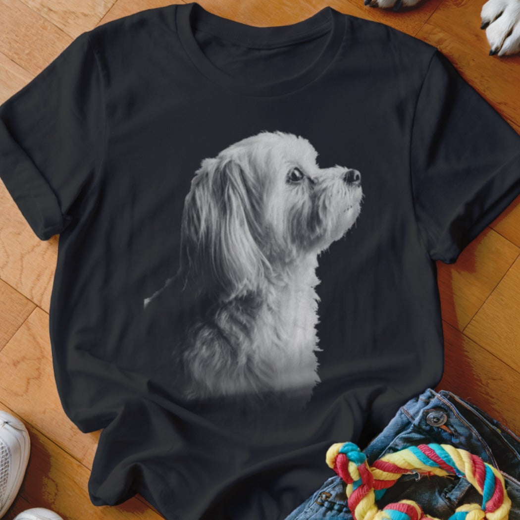 Black t-shirt with a black and white print of a fluffy white dog looking up and to the right.