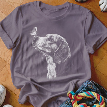 A gray short-sleeve t-shirt printed with a white sketch of a dog looking at a butterfly on its nose.