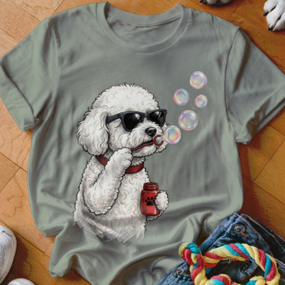 Sage green t-shirt featuring a graphic of a white poodle wearing sunglasses and blowing bubbles.