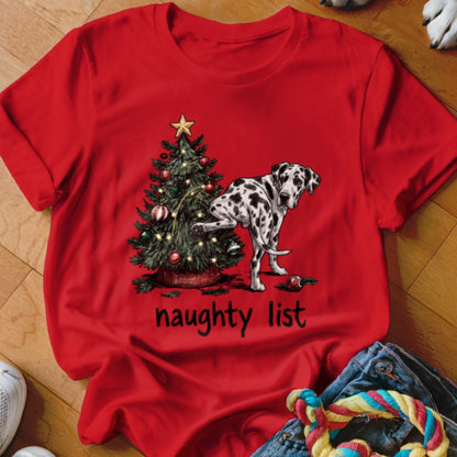 Dalmatian dog next to a Christmas tree with text "naughty list".