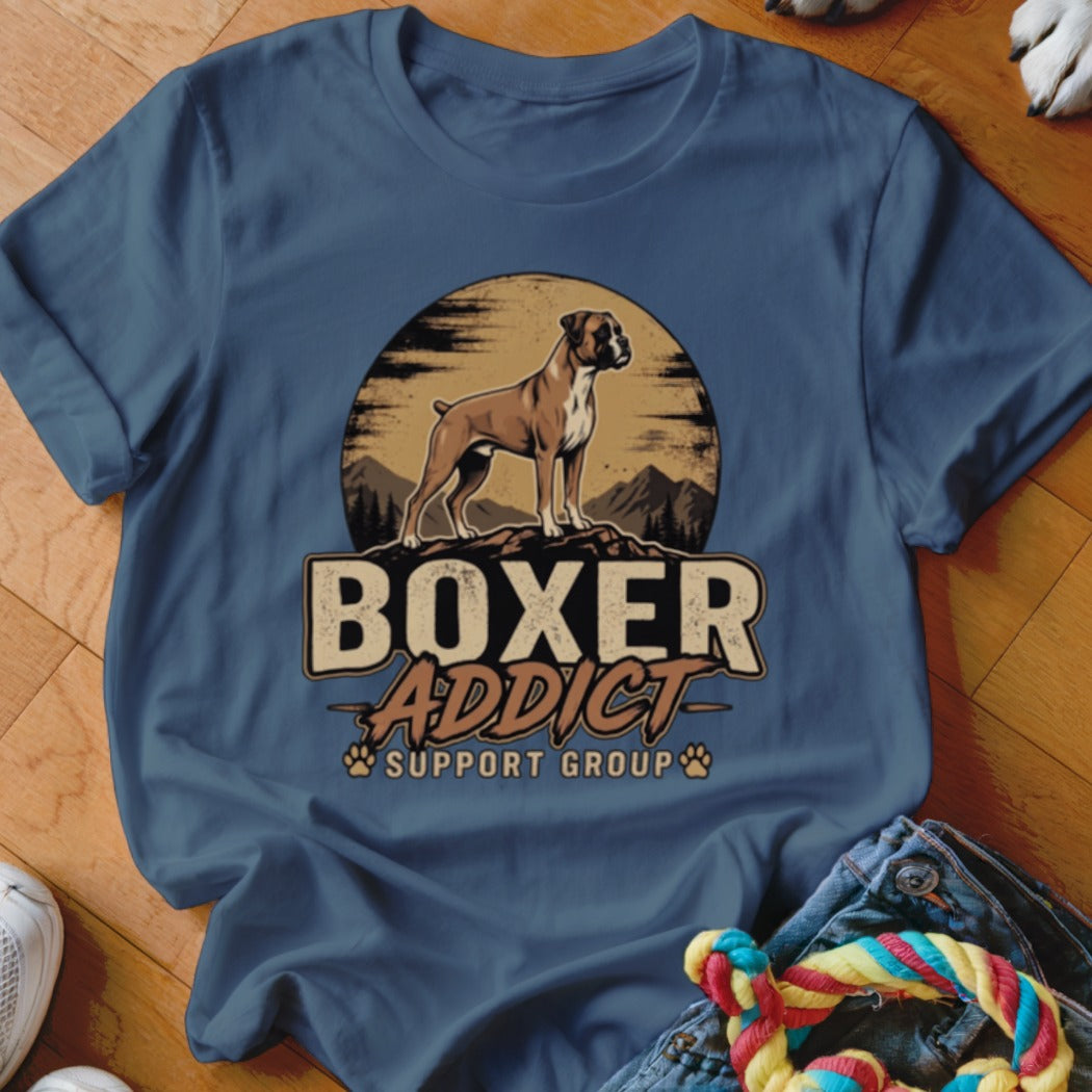 A blue t-shirt featuring a graphic of a Boxer dog, mountains, and the text Boxer Addict Support Group.