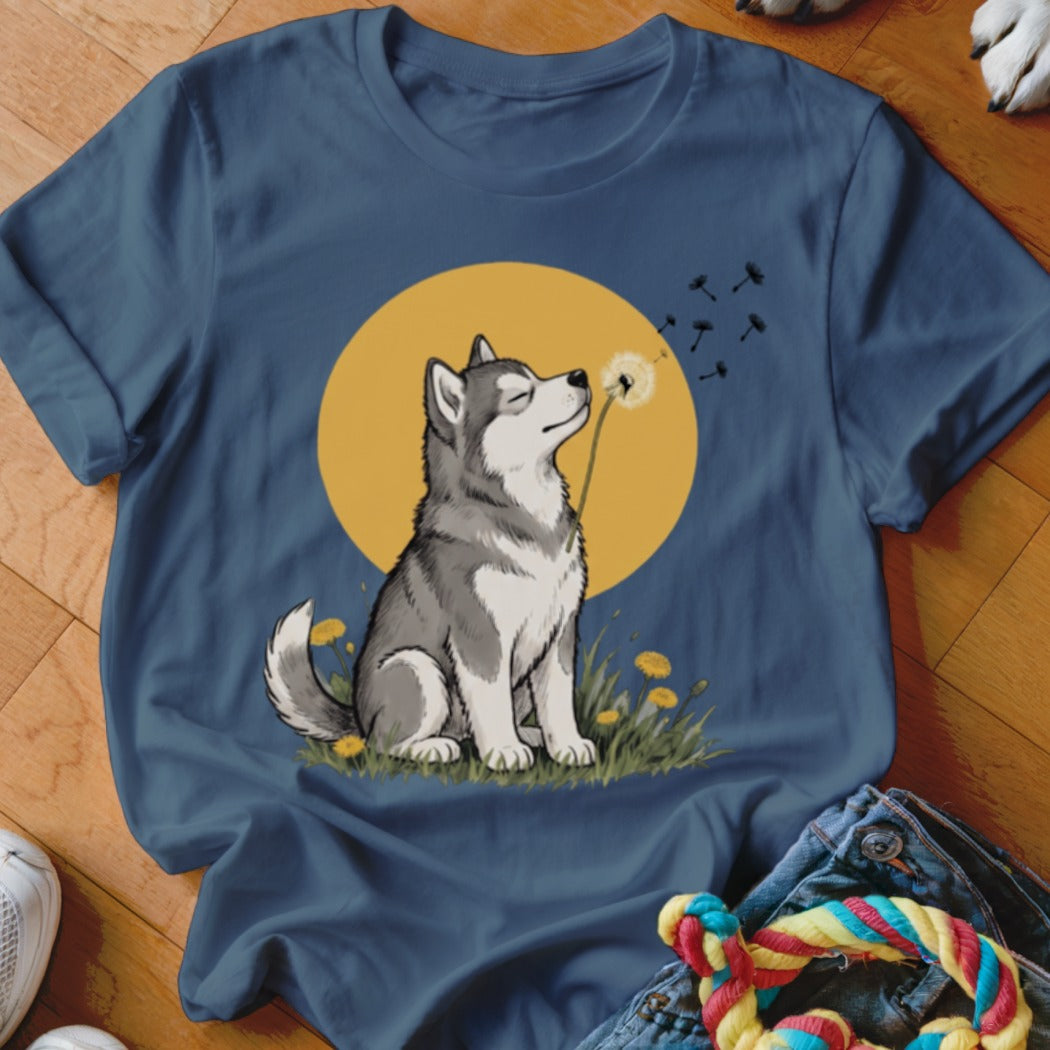 Navy blue t-shirt featuring an illustration of a husky blowing a dandelion in front of a yellow moon.