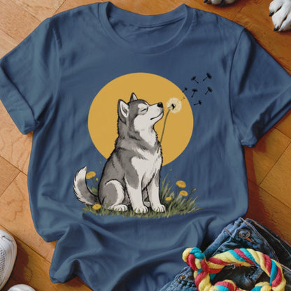 Navy blue t-shirt featuring an illustration of a husky blowing a dandelion in front of a yellow moon.