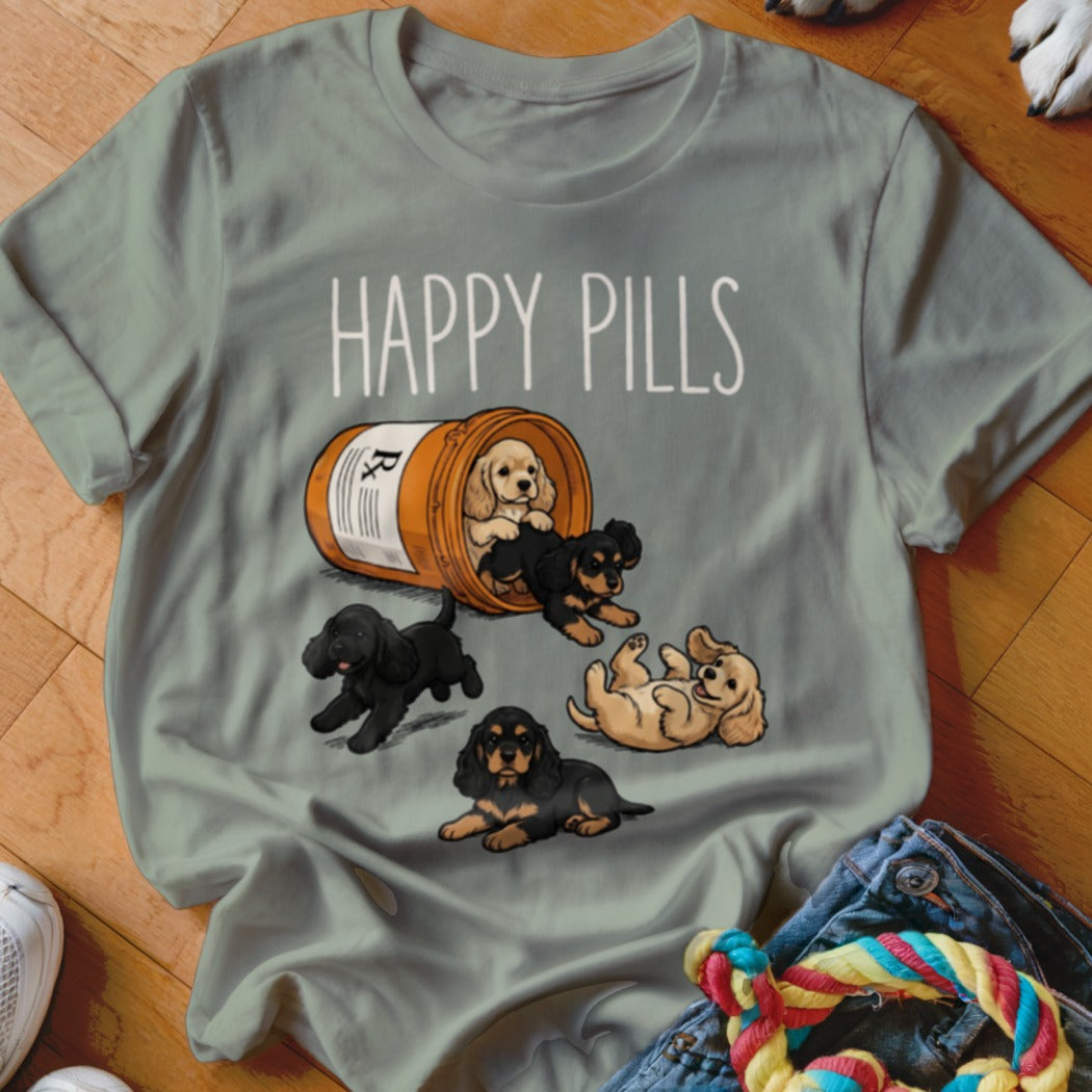T-shirt with five puppies spilling from a prescription bottle, text reads "HAPPY PILLS".
