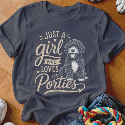 Dark gray t-shirt with cream text and illustration of a doodle dog saying "Just a girl who loves Porties."
