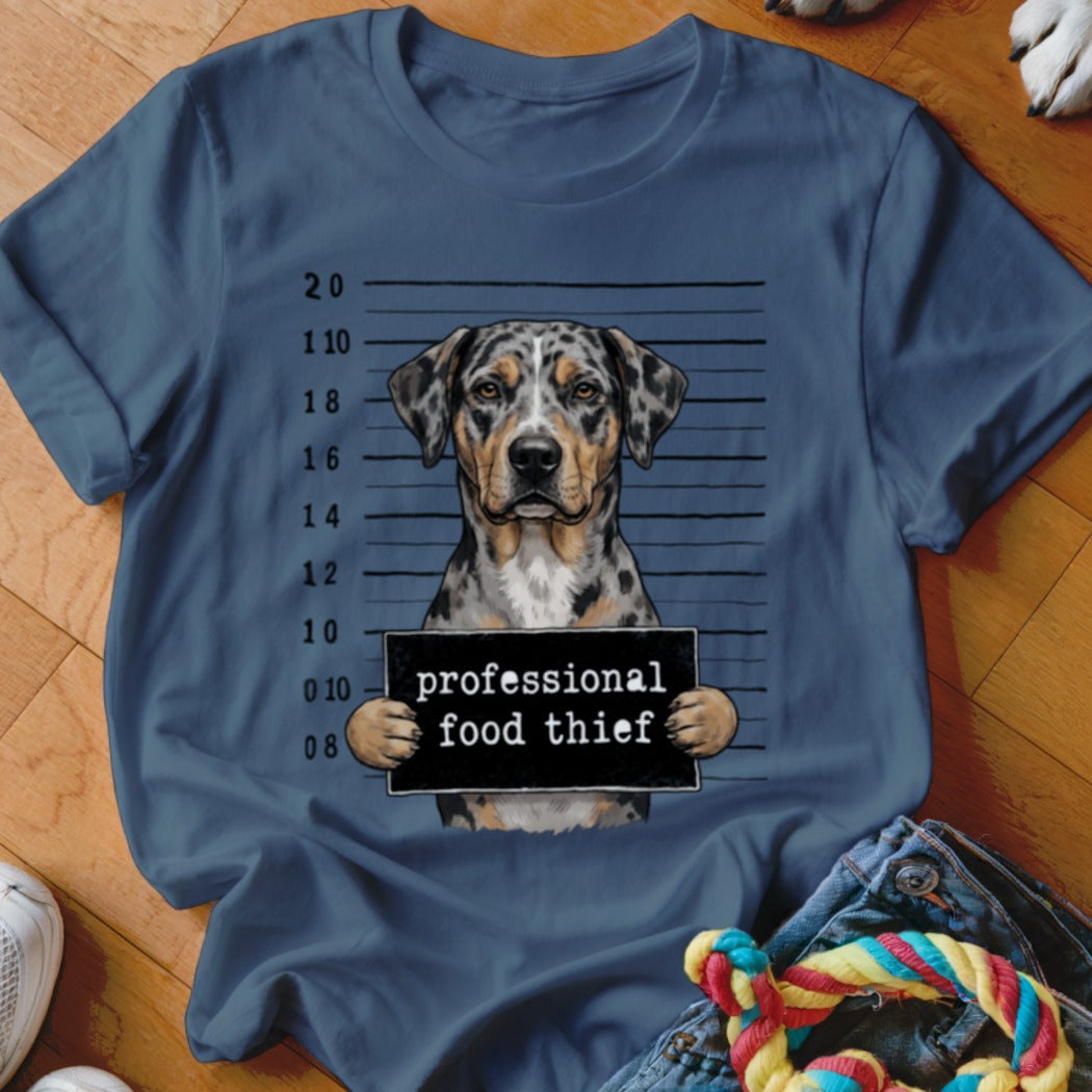 Catahoula dog mugshot with "professional food thief" sign.
