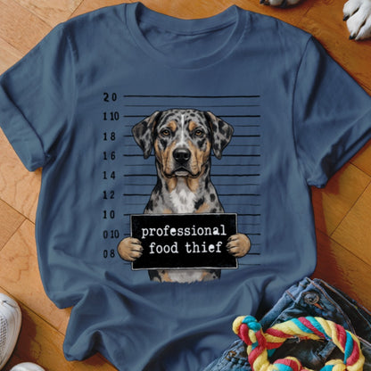 Catahoula dog mugshot with "professional food thief" sign.
