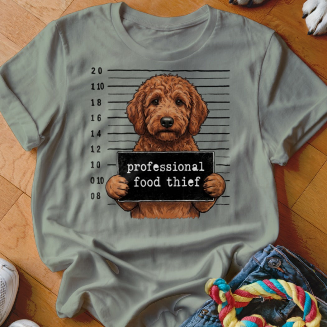 Dog with mugshot sign that reads "professional food thief."
