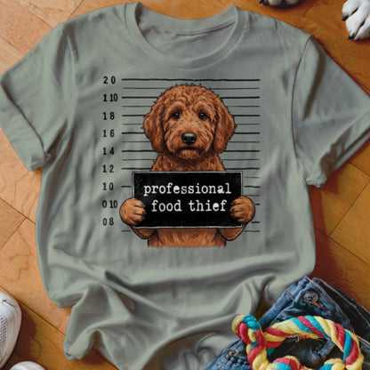 Dog with mugshot sign that reads "professional food thief."