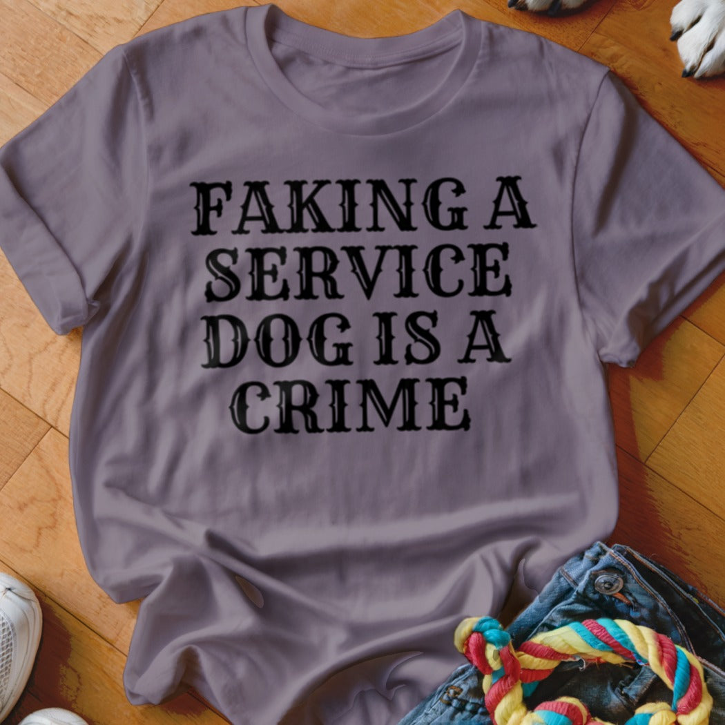 T-shirt with text "Faking a service dog is a crime" in black font.