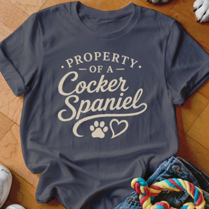 Dark blue t-shirt with "Property of a Cocker Spaniel" text and paw print heart.